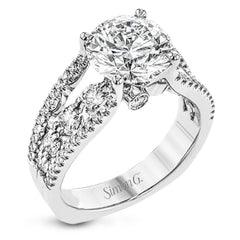 This 18k white gold engagment ring is a modern take on a classic design with 1.12 ctw of round white diamonds.