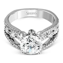 This 18k white gold engagment ring is a modern take on a classic design with 1.12 ctw of round white diamonds.