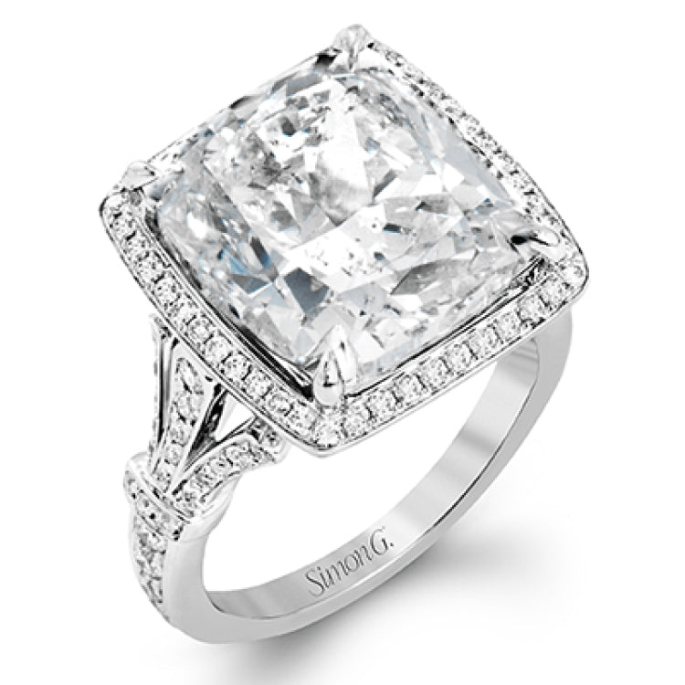 A bright blue 9.57 ct aquamarine is the central focus of this classic halo 18k white gold ring set with .68 ctw of white diamonds.