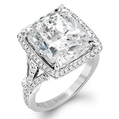 A bright blue 9.57 ct aquamarine is the central focus of this classic halo 18k white gold ring set with .68 ctw of white diamonds.
