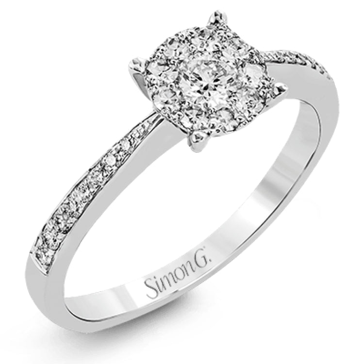 This delightful ring is crafted from 18k white gold and features a .30 ct white diamond in the center of .50 ctw of smaller round white diamonds.