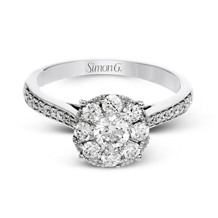 This delightful ring is crafted from 18k white gold and features a .30 ct white diamond in the center of .50 ctw of smaller round white diamonds.