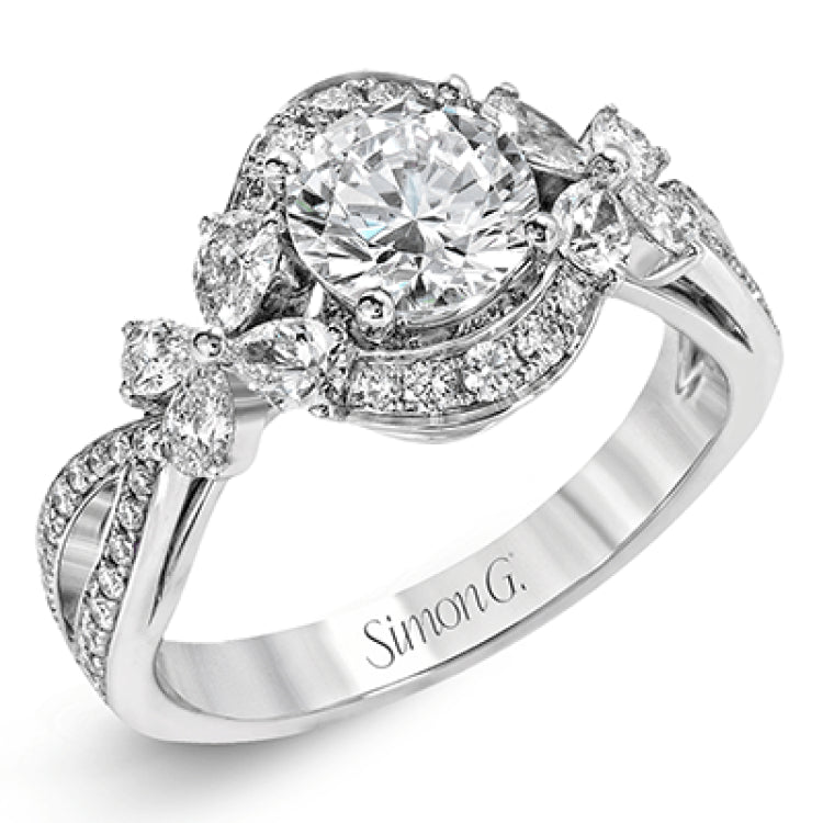 Dramatic yet romantic, this exquisite white gold engagement ring features .30 ctw of round cut white diamonds highlighted by .54 ctw of pear shaped diamonds in delicate floral motifs.
