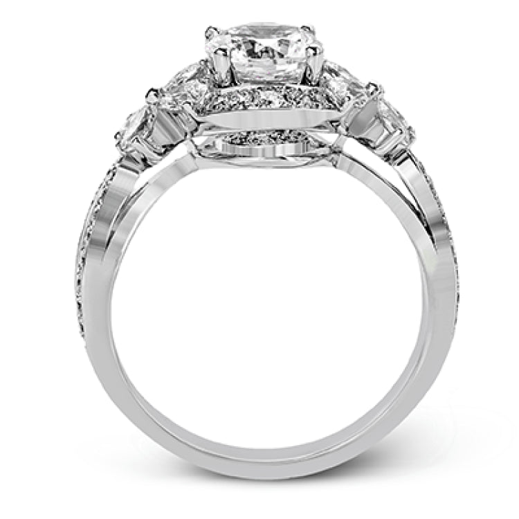 Dramatic yet romantic, this exquisite white gold engagement ring features .30 ctw of round cut white diamonds highlighted by .54 ctw of pear shaped diamonds in delicate floral motifs.