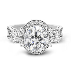 Dramatic yet romantic, this exquisite white gold engagement ring features .61 ctw of round cut white diamonds highlighted by .58 ctw of pear shaped diamonds in delicate floral motifs.