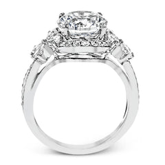Dramatic yet romantic, this exquisite white gold engagement ring features .61 ctw of round cut white diamonds highlighted by .58 ctw of pear shaped diamonds in delicate floral motifs.