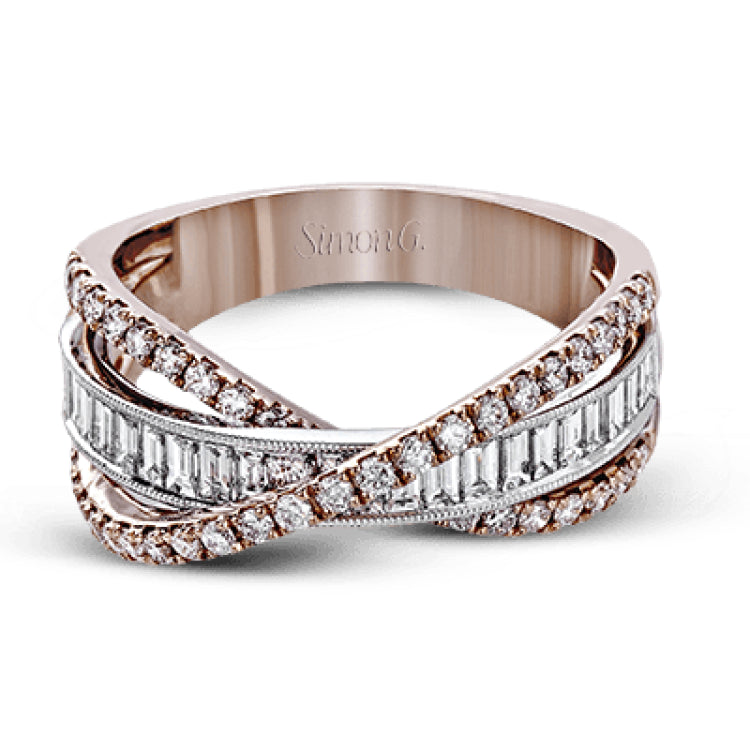 This modern 18k two-tone gold ring stands out from the crown with an overlapping design set with .42 ctw of round diamonds and .65 ctw of baguette diamonds.