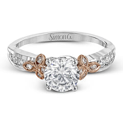 This delicate white gold ring features lovely rose gold accents on the shank and is set with .24 ctw of round cut white diamond accents.