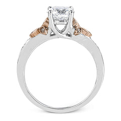 This delicate white gold ring features lovely rose gold accents on the shank and is set with .24 ctw of round cut white diamond accents.