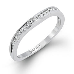 This delicate white gold ring features lovely rose gold accents on the shank and is set with .24 ctw of round cut white diamond accents.