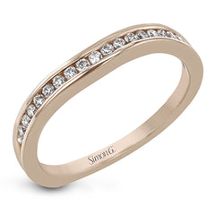 This delicate white gold ring features lovely rose gold accents on the shank and is set with .24 ctw of round cut white diamond accents.