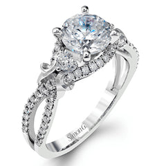Featuring a delicately twisted shank, this brilliant white gold engagement ring and complimentary wedding band are set with .55 ctw of round cut white diamonds.