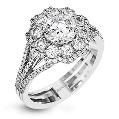 This lovely modern white gold ring features an eye-catching cluster halo set with .97 ctw shimmering round cut white diamonds.