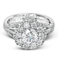 This lovely modern white gold ring features an eye-catching cluster halo set with .97 ctw shimmering round cut white diamonds.