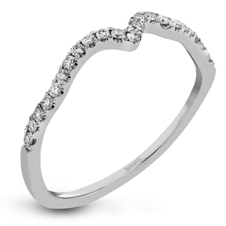 Featuring delicate floral designs on the shank, this modern white gold ring is complemented by .19 ctw of round cut white diamonds and .02 ctw pink diamond accents.
