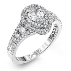 Featuring a pear-shaped double halo, this modern white gold engagement ring is highlighted by .68 ctw of round cut white diamonds.