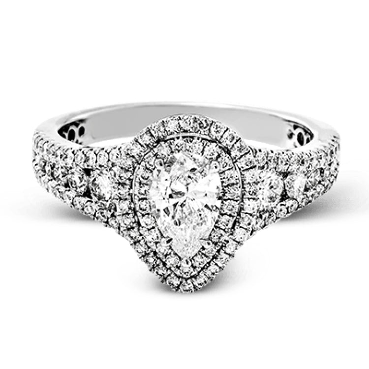 Featuring a pear-shaped double halo, this modern white gold engagement ring is highlighted by .68 ctw of round cut white diamonds.