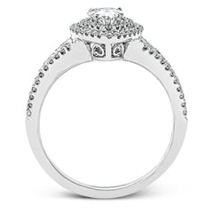 Featuring a pear-shaped double halo, this modern white gold engagement ring is highlighted by .68 ctw of round cut white diamonds.