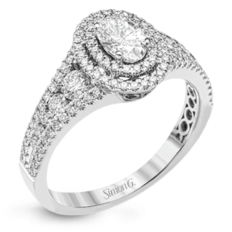 Featuring an exquisite contemporary design, this white gold engagement ring features an eye-catching oval double halo complemented by .68 ctw of round cut white diamonds.
