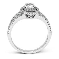 Featuring an exquisite contemporary design, this white gold engagement ring features an eye-catching oval double halo complemented by .68 ctw of round cut white diamonds.