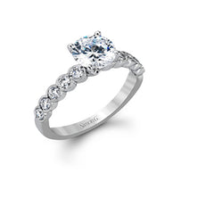 This engagement and wedding band set combines old and new with 1.09 ctw of round brilliant diamonds bezel set into 18k white gold, accented with vintage-inspired milgrain.