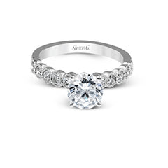 This engagement and wedding band set combines old and new with 1.09 ctw of round brilliant diamonds bezel set into 18k white gold, accented with vintage-inspired milgrain.