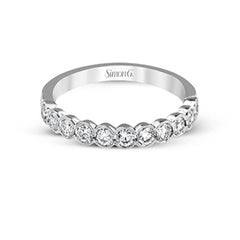 This engagement and wedding band set combines old and new with 1.09 ctw of round brilliant diamonds bezel set into 18k white gold, accented with vintage-inspired milgrain.