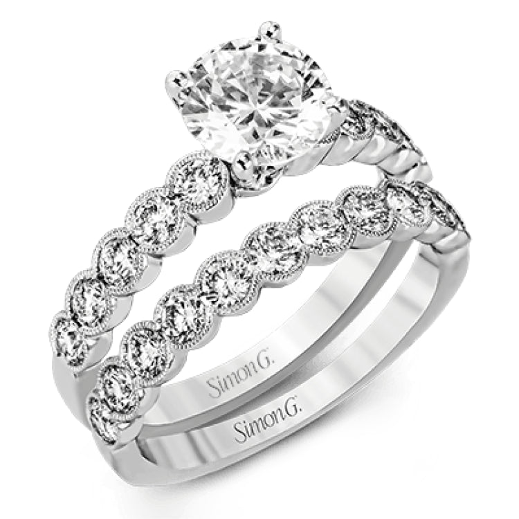 This engagement and wedding band set combines old and new with 1.09 ctw of round brilliant diamonds bezel set into 18k white gold, accented with vintage-inspired milgrain.