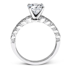 This engagement and wedding band set combines old and new with 1.09 ctw of round brilliant diamonds bezel set into 18k white gold, accented with vintage-inspired milgrain.