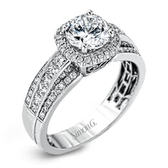 Featuring an impressive halo, this contemporary white gold engagement ring is accented by .22 ctw of round cut white diamonds and .42 ctw princess cut diamonds.