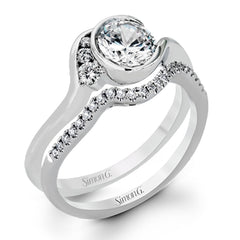 This distinctive, swirling ring design is set with .19 ctw and holds the center stone in a partial bezel setting.