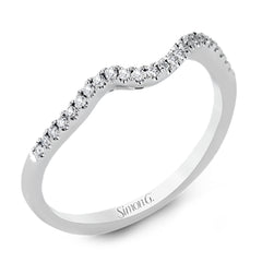 This distinctive, swirling ring design is set with .19 ctw and holds the center stone in a partial bezel setting.