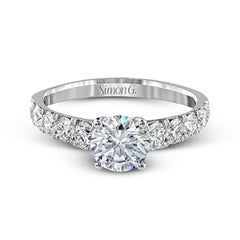 Simple yet dazzling, this white gold engagement ring features .89 ctw of round white diamonds set into the shank.