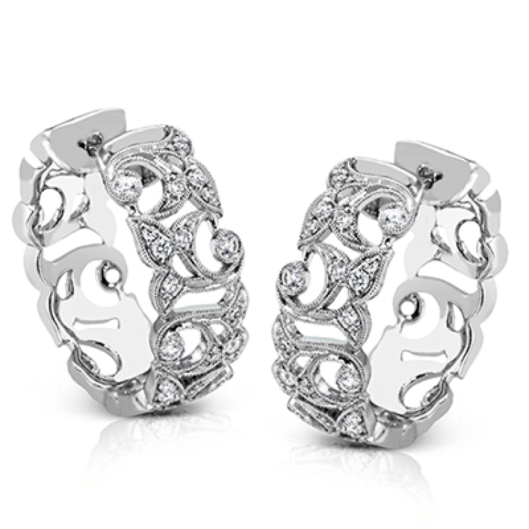 These traditional white gold hoop earrings reflect a romantic floral openwork design accented with .37 ctw of shimmering white diamonds.