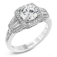 This design is a modern take on a classic design, with .29 ctw of round diamonds set into its halo and sides, and .31 ctw of baguette diamonds flanking the center stone.