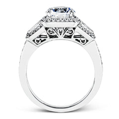 This design is a modern take on a classic design, with .29 ctw of round diamonds set into its halo and sides, and .31 ctw of baguette diamonds flanking the center stone.