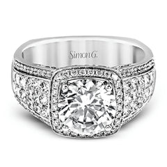 This romantic white gold contemporary ring is accentuated by .25 ctw of glistening round cut white diamonds and .94 ctw of princess cut diamonds.