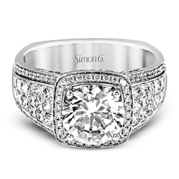This romantic white gold contemporary ring is accentuated by .25 ctw of glistening round cut white diamonds and .94 ctw of princess cut diamonds.