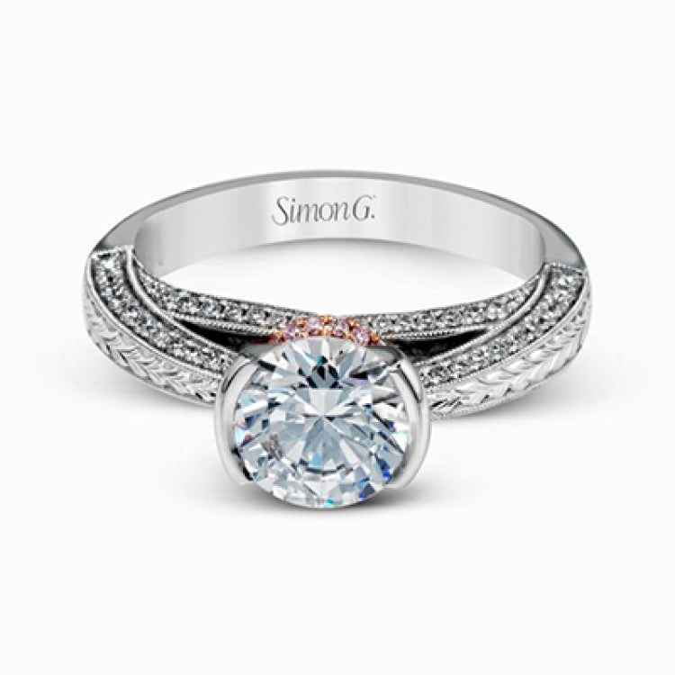 This exquisite white gold engagement ring is highlighted by .04 ctw of princess cut white diamonds and .34 ctw of round cut white diamonds.
