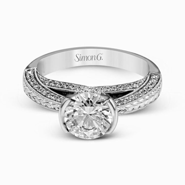 This exquisite white gold engagement ring is highlighted by .04 ctw of princess cut white diamonds and .34 ctw of round cut white diamonds.