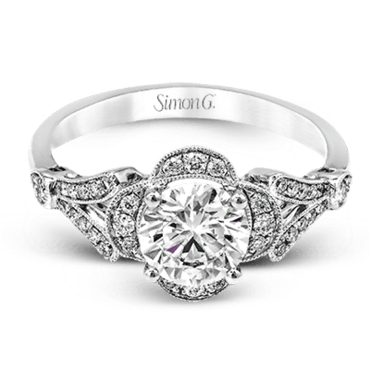 Accentuated with an impressive halo design, this contemporary white gold ring features .21 ctw round cut white diamonds.