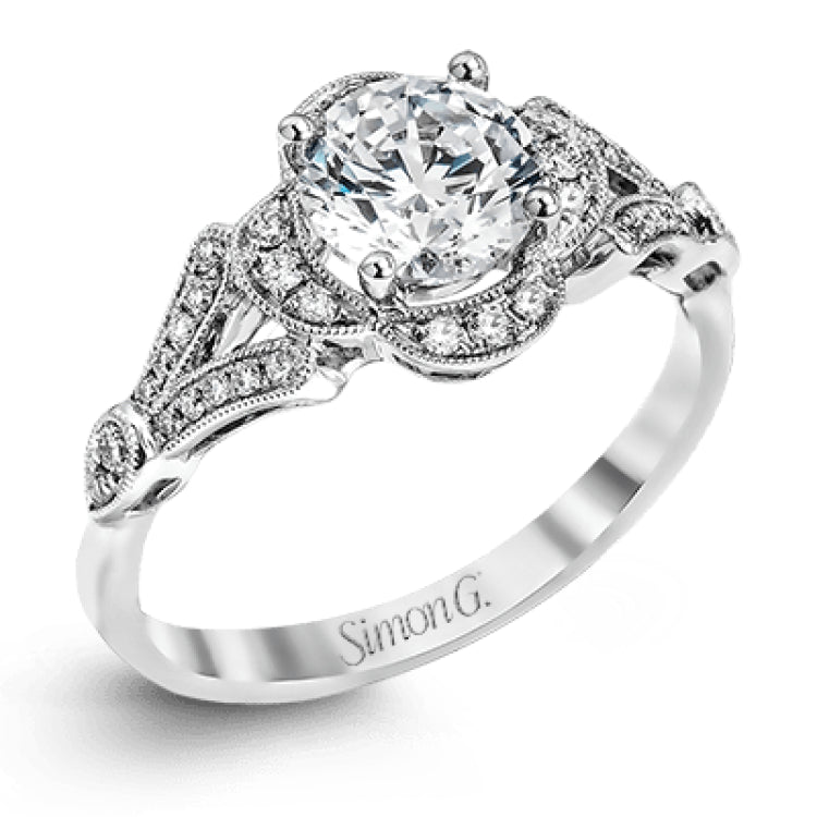 Accentuated with an impressive halo design, this contemporary white gold ring features .21 ctw round cut white diamonds.
