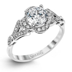 Accentuated with an impressive halo design, this contemporary white gold ring features .21 ctw round cut white diamonds.