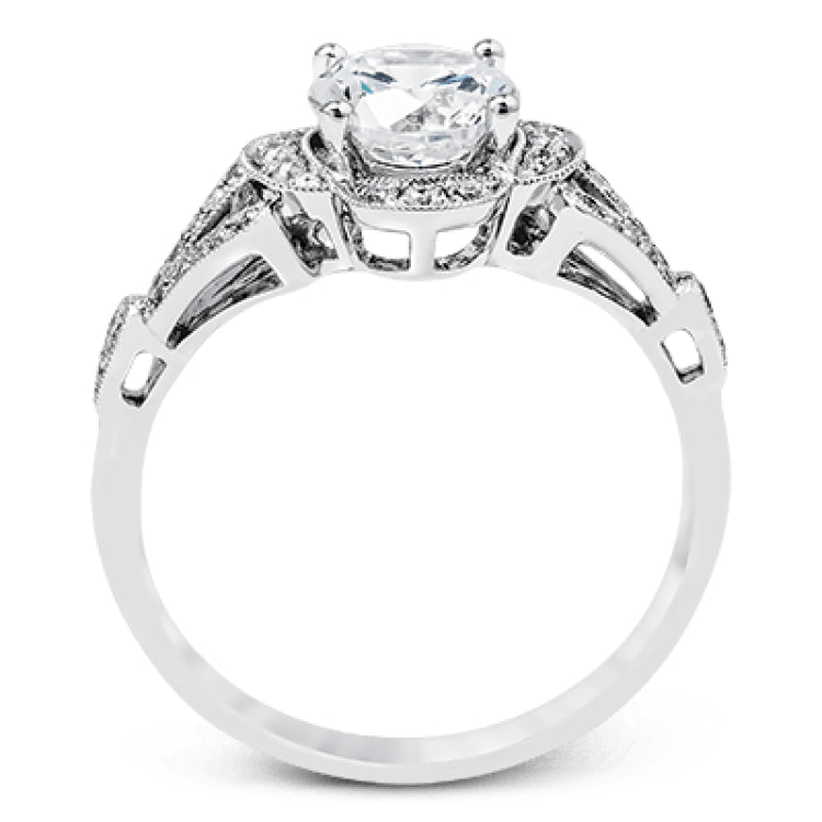Accentuated with an impressive halo design, this contemporary white gold ring features .21 ctw round cut white diamonds.