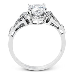 Accentuated with an impressive halo design, this contemporary white gold ring features .21 ctw round cut white diamonds.