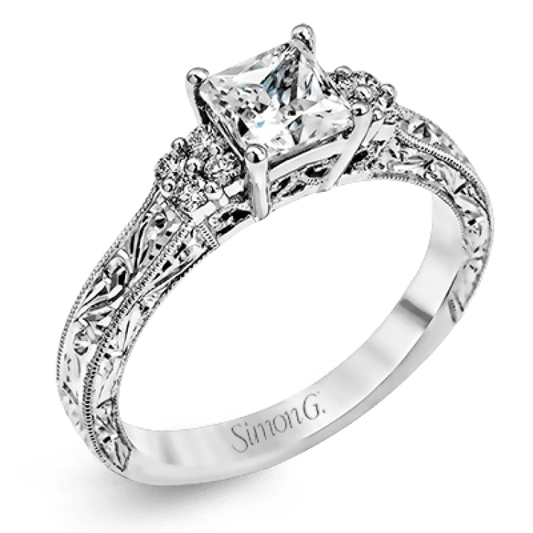 Featuring a dazzling vintage design, this romantic white gold engagement ring is highlighted by .15 ctw of striking white diamonds.