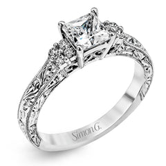 Featuring a dazzling vintage design, this romantic white gold engagement ring is highlighted by .15 ctw of striking white diamonds.