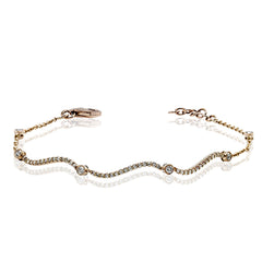 This curving gold bracelet is incredibly comfortable to wear due to its flexible design that sparkles with .50 ctw of white diamonds.