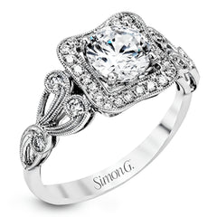 The lovely vintage design of this impressive white gold ring is emphasized by .27 ctw sparkling round cut white diamonds.