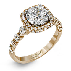 The delicate design of this classic white gold engagement ring features a sparkling pave halo accented with .86 ctw of shimmering round cut white diamonds.